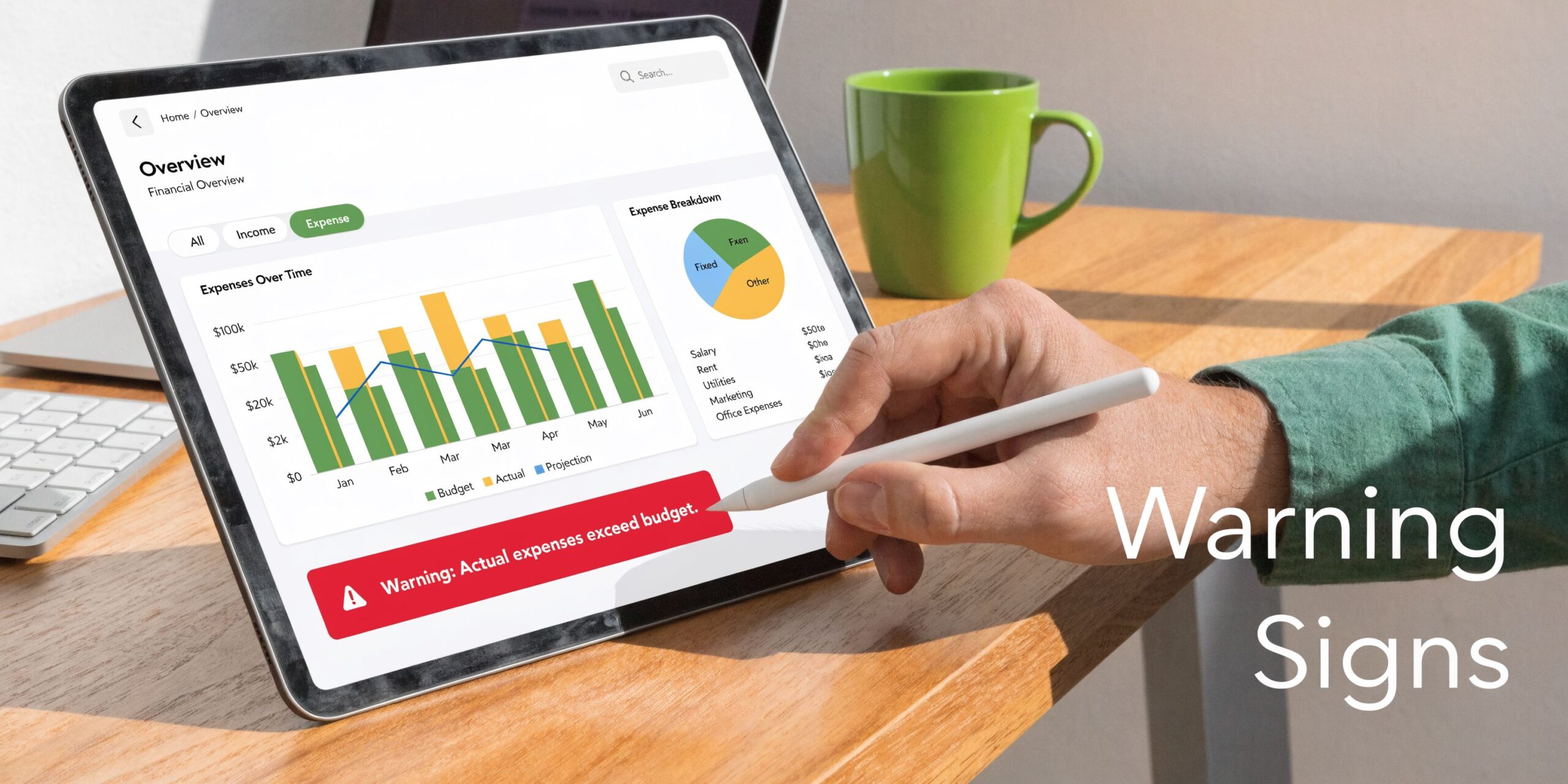 A person using a stylus on a tablet showing financial budget warning signs on a screen.