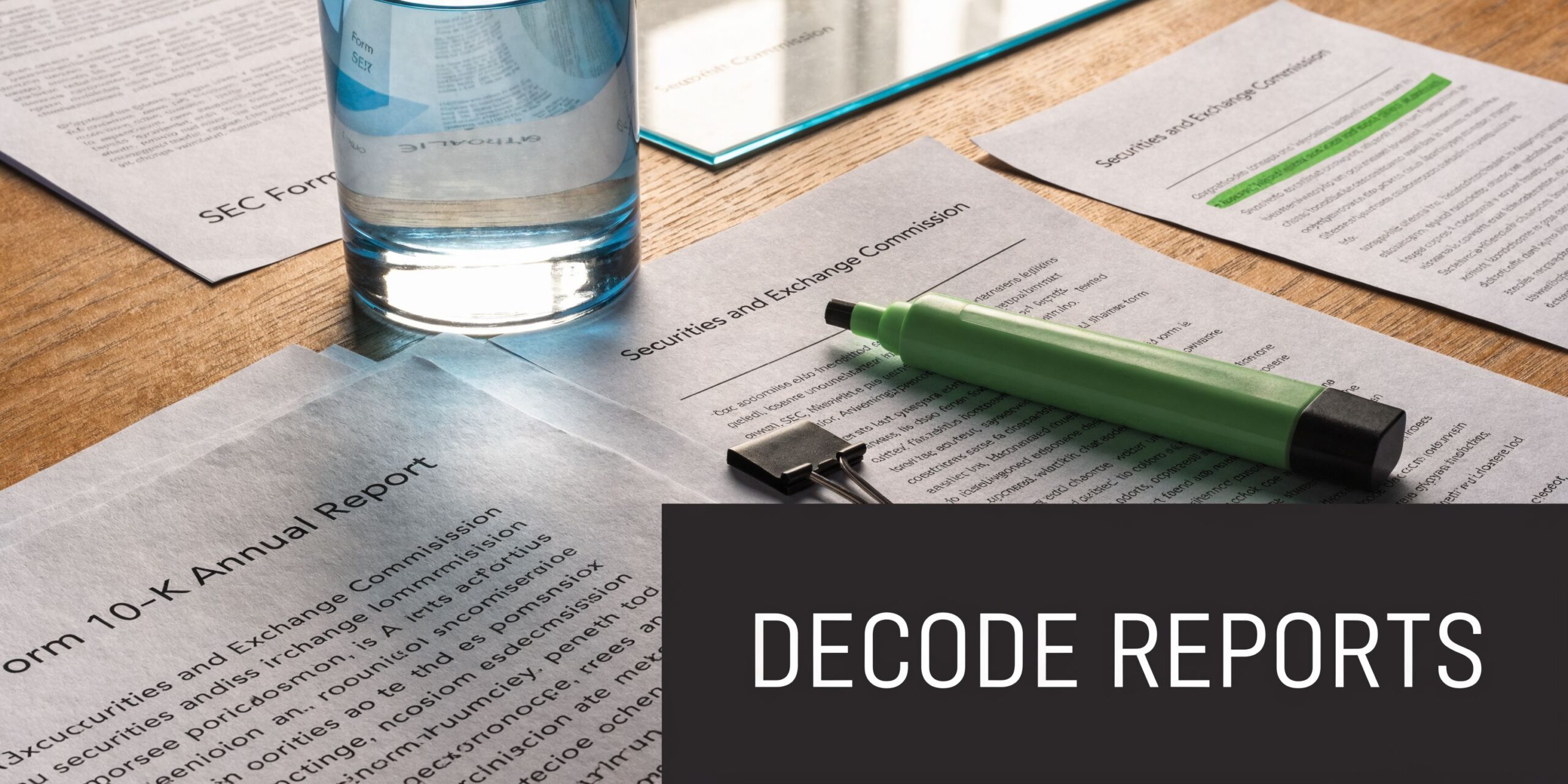 A green highlighter rests on financial documents titled Securities and Exchange Commission with a glass of water nearby.
