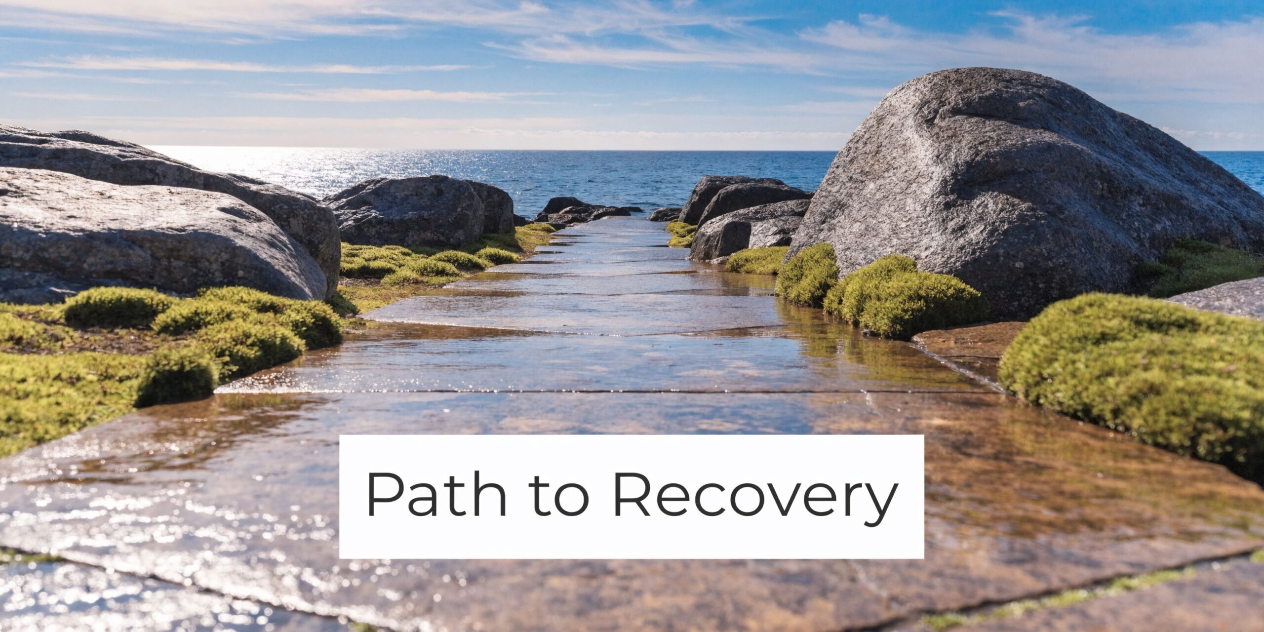 A scenic stone pathway leading towards the ocean under a bright sky with the text Path to Recovery.