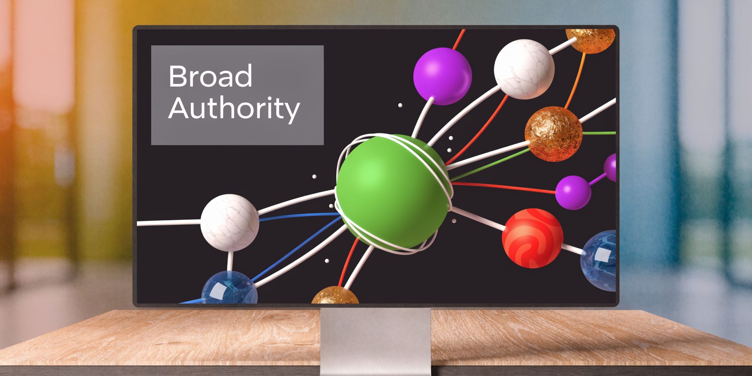 A computer monitor displaying a 3D graphic of interconnected spheres with the text Broad Authority.